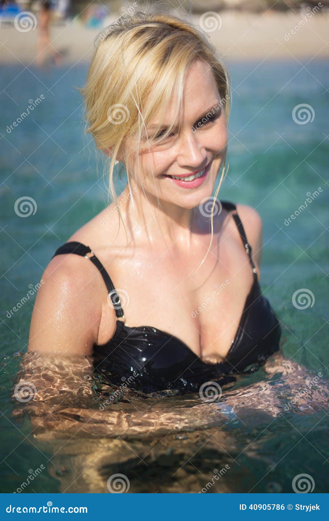 Beautiful blonde woman swimming in the ocean in ibiza