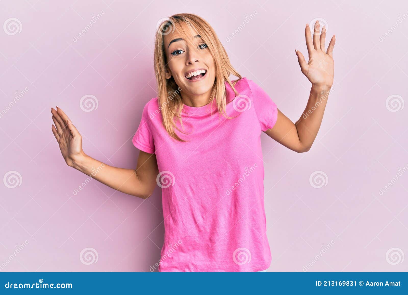 Beautiful Blonde Woman Wearing Casual Pink Tshirt Clueless And Confused Expression With Arms And