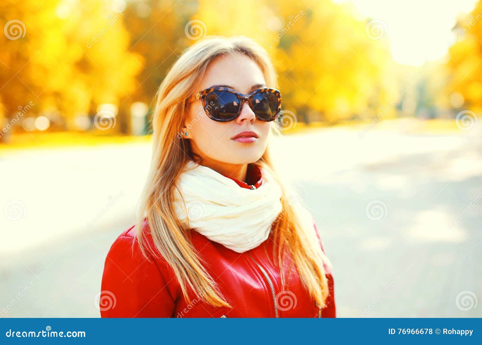 Beautiful Blonde Woman Wearing A Sunglasses And Red Jacket With Scarf