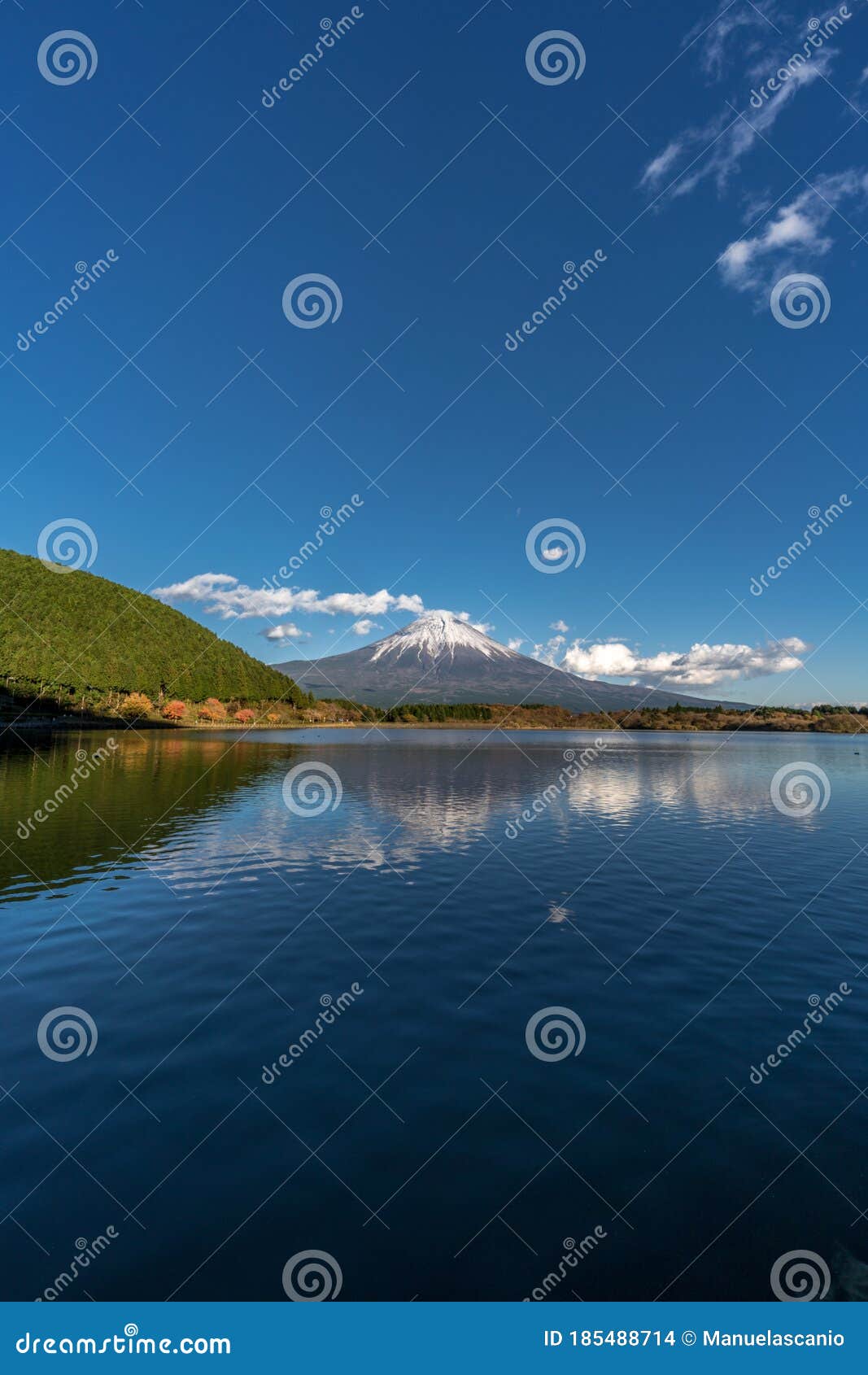 beautiful blue sky at tanuki lake tanukiko. fuji mountain reflections, first snow in autumn season. japan