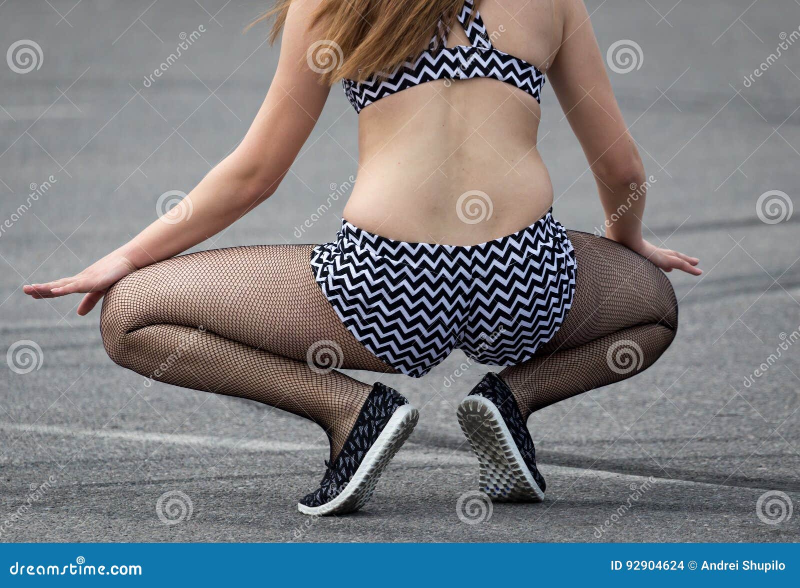 Girl in pantyhose andi shorts posing in pubblic park Stock Photo