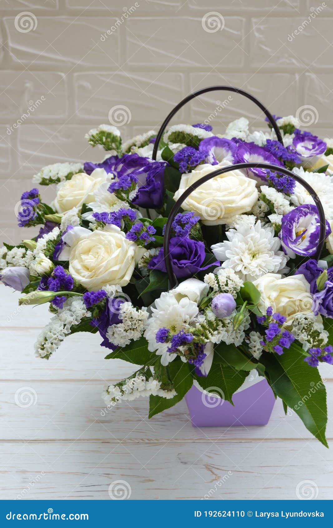 Beautiful bouquet of purple and white flowers with wrapping paper and  ribbons on white isolated background Stock Photo - Alamy