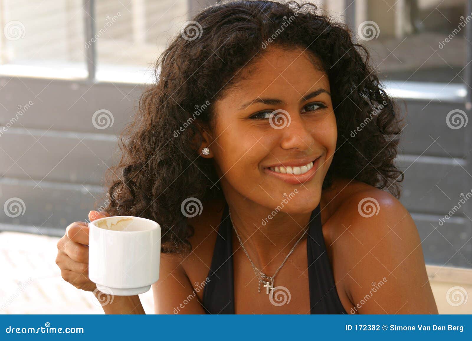 A Beautiful Brazilian Woman In A Red Dress Poses In The Studio Stock ...