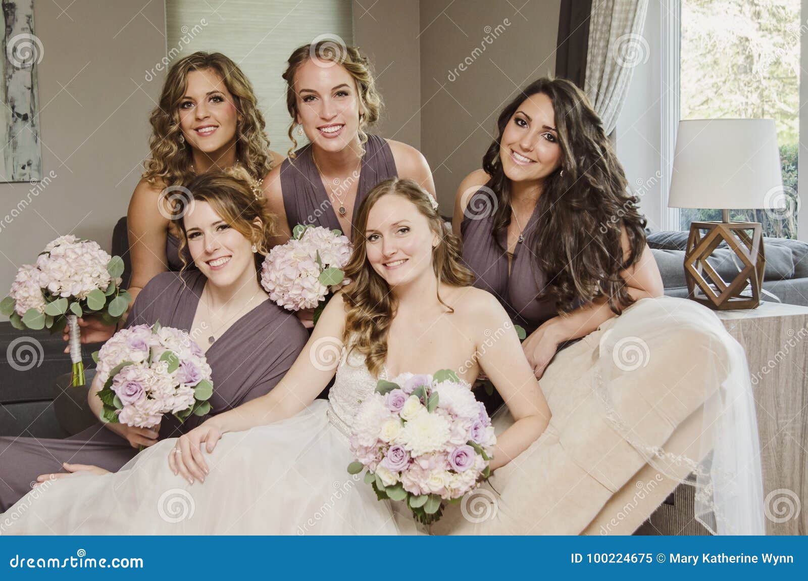 beautiful bride and bridesmaids on couch