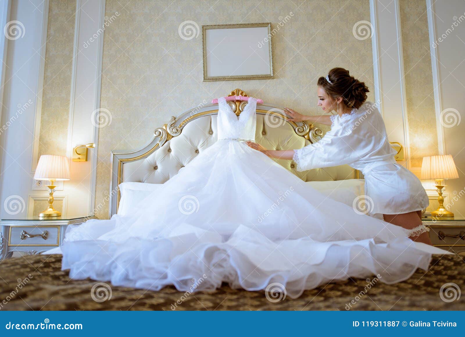 Beautiful Bride In Robe Is Watching A Wedding Dress Stock Image Image Of Curly Couple 119311887