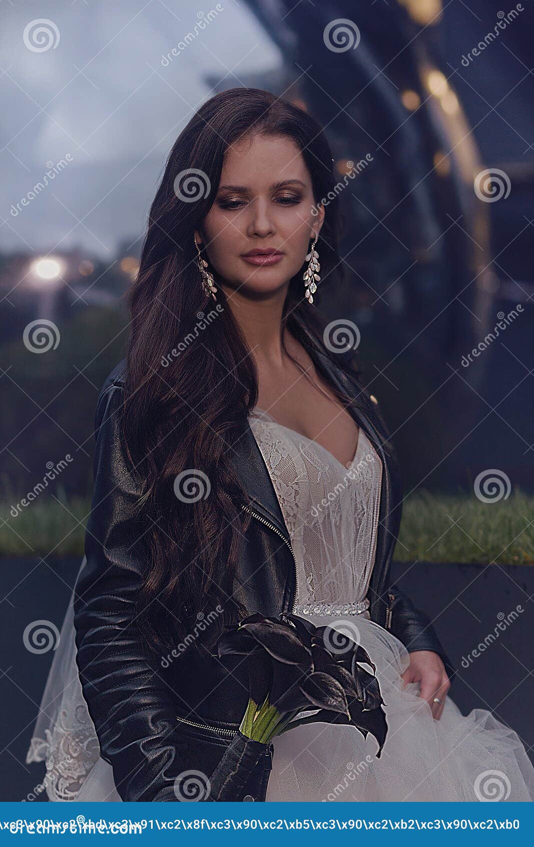 A Beautiful Bride in a Wedding Dress and a Leather Jacket with a ...