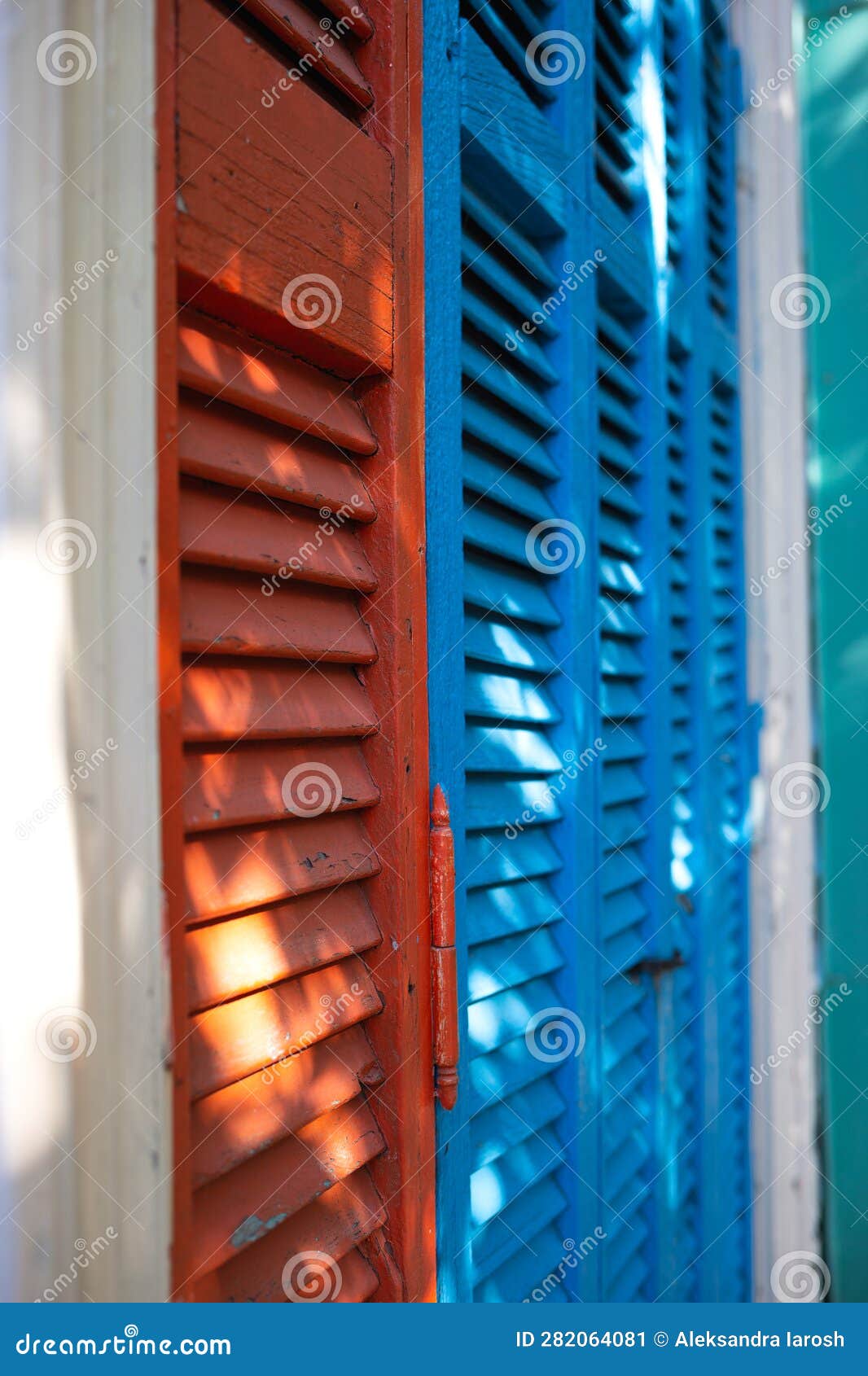 beautiful bright colorful and authentic red and blue shutters of ancient houses
