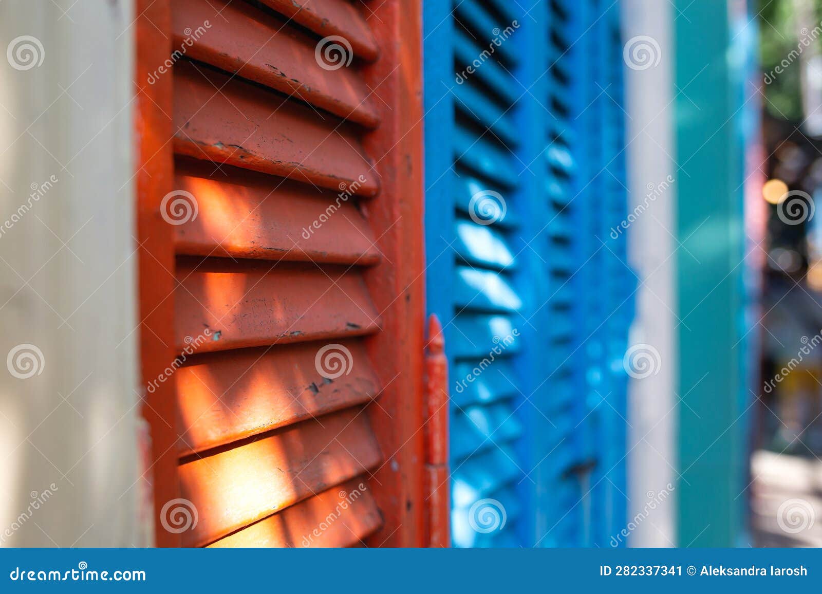 beautiful bright colorful and authentic red and blue shutters of ancient houses