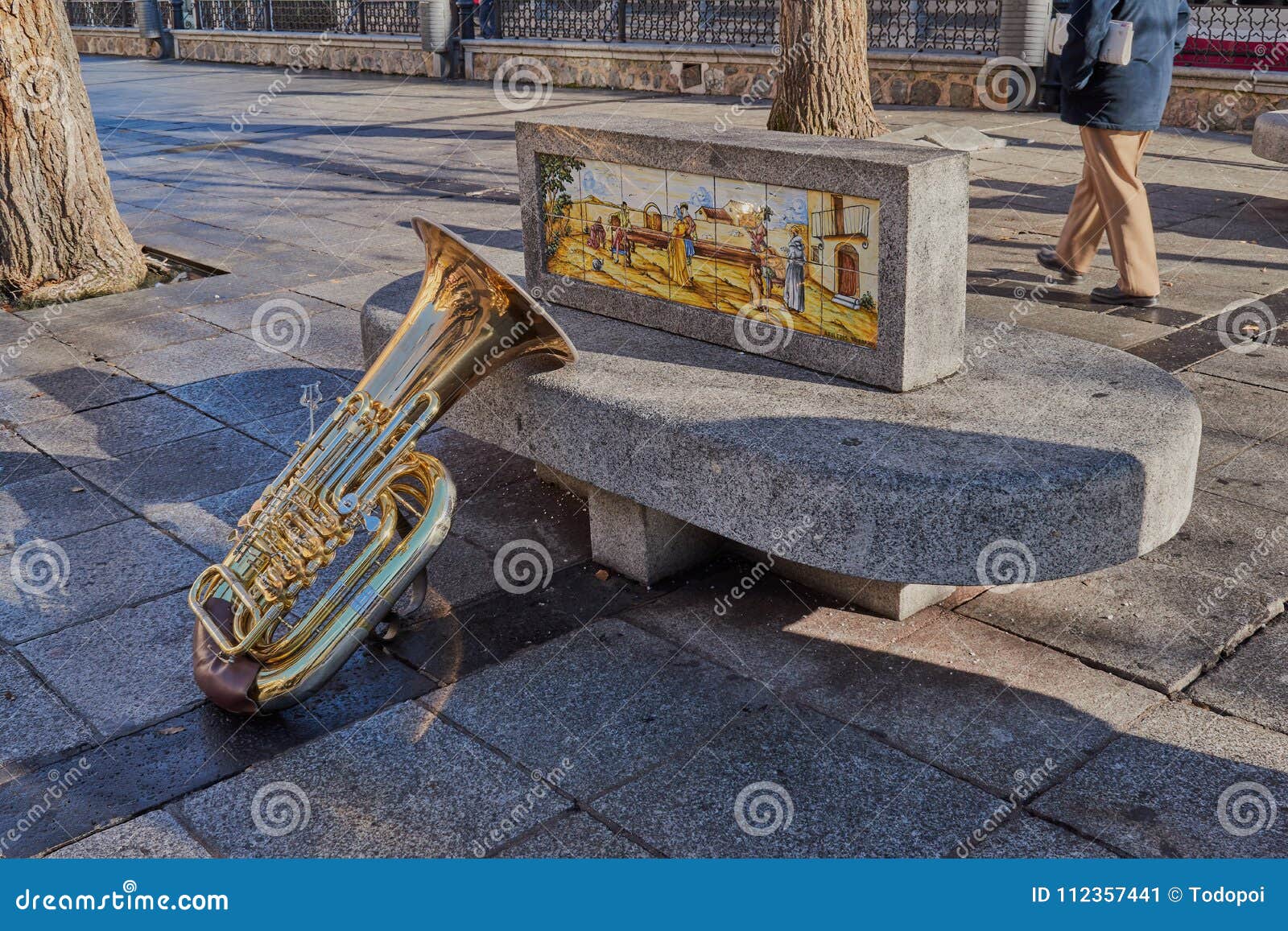 beautiful and bright tuba resting on a stone bench with ornament in the plaza de zocodover, spain