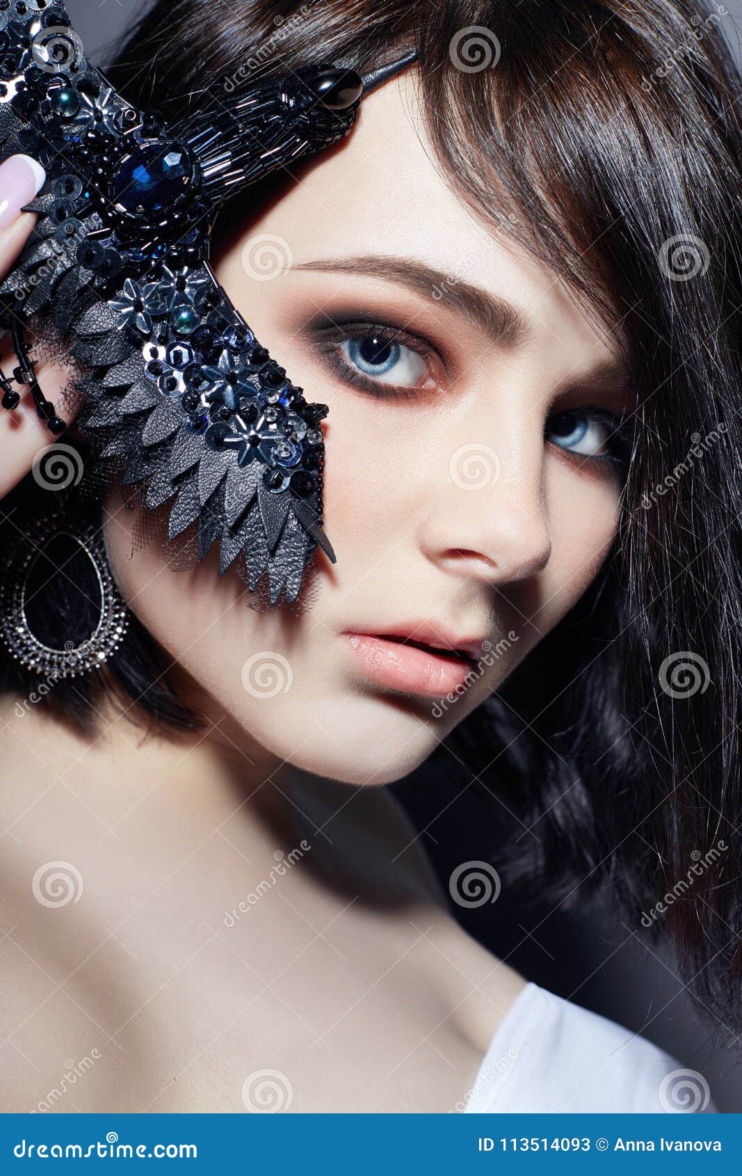Beautiful Brunette Girl With Big Blue Eyes Holding A Black Brooch