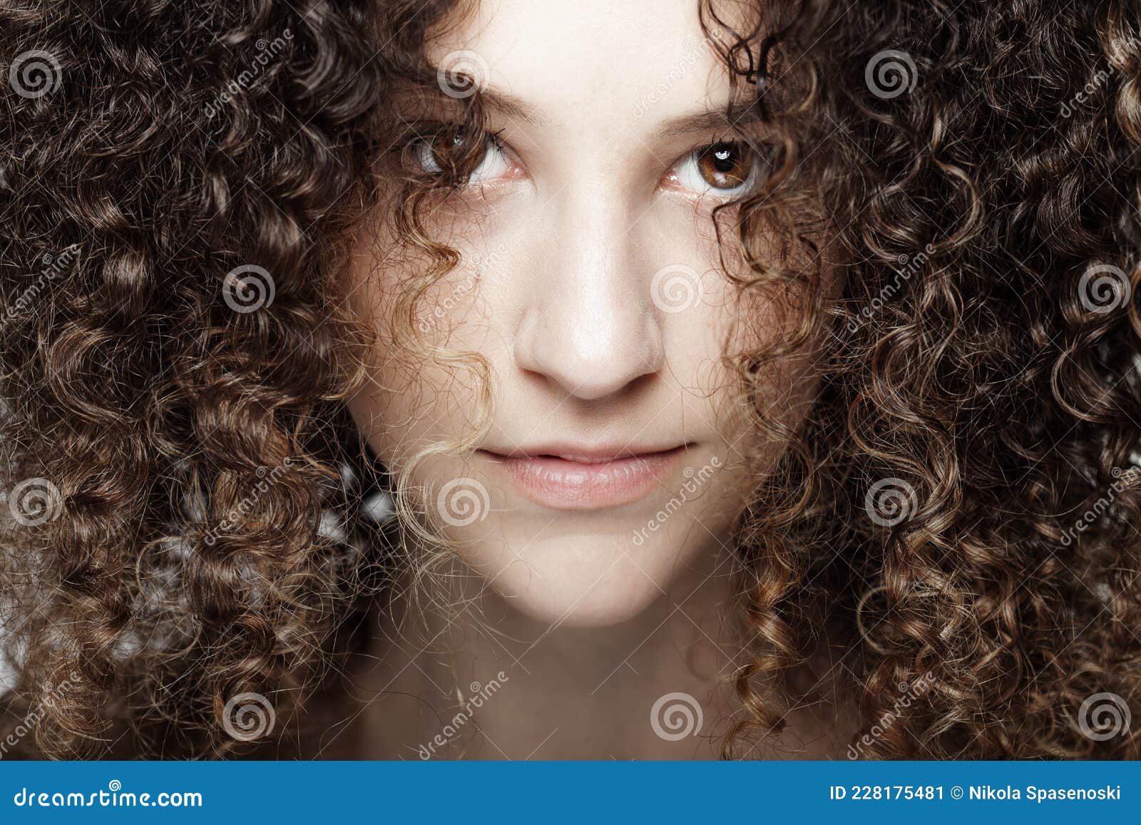 Beautiful Brunette Girl with Long Curly Hair. Closeup Studio Portrait ...