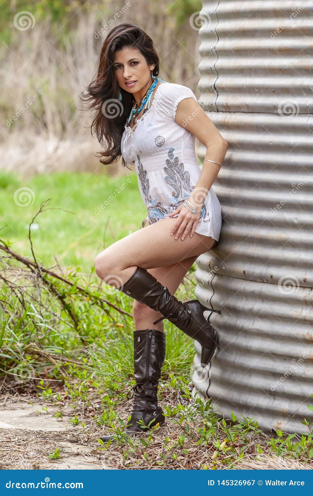 A Lovely Brunette Model Posing Outdoors With The Latest Fashions Stock