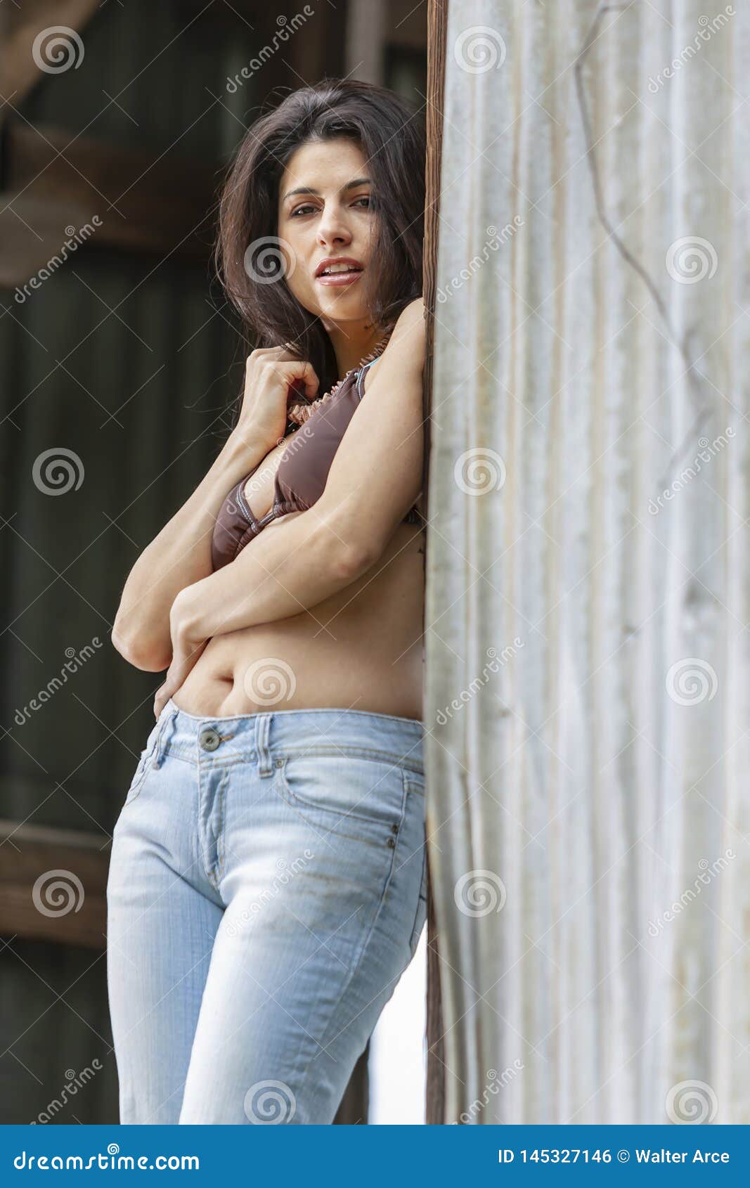 A Lovely Brunette Model Posing Outdoors With The Latest Fashions Stock