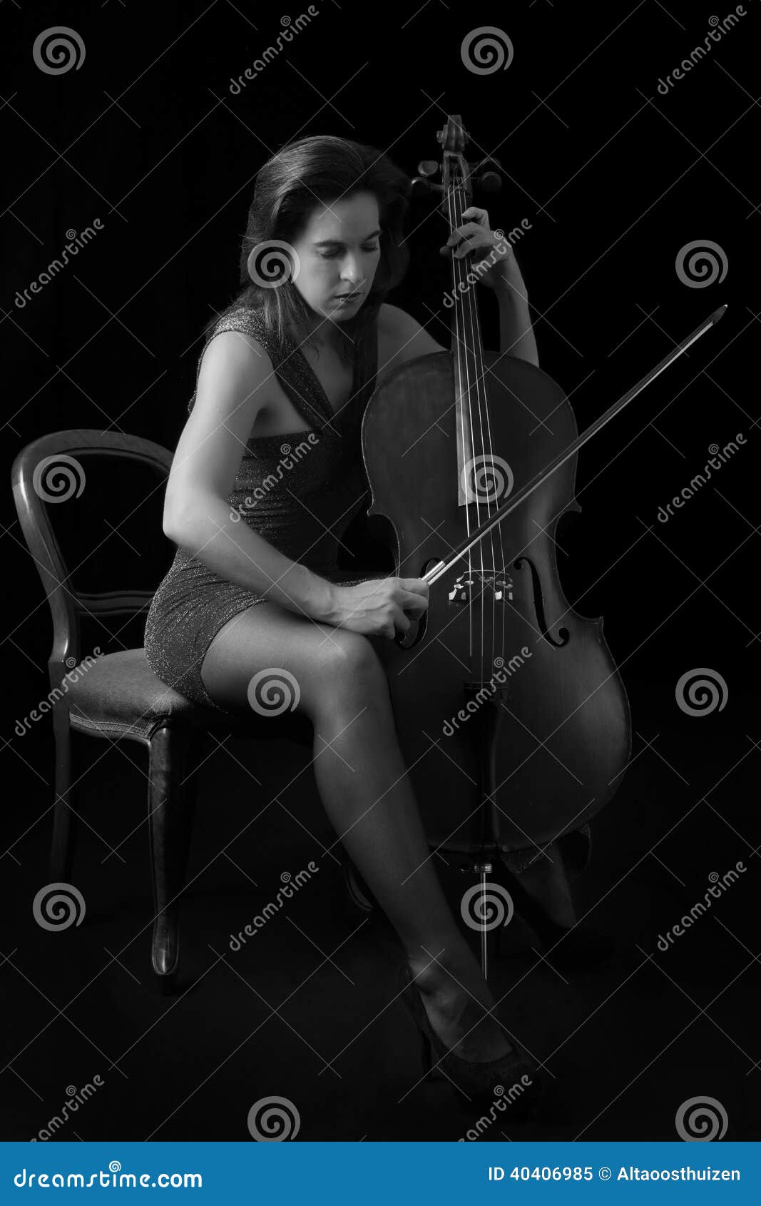 Beautiful Playing Cello with Selective Light in Red Dress Artistic Conversion Stock