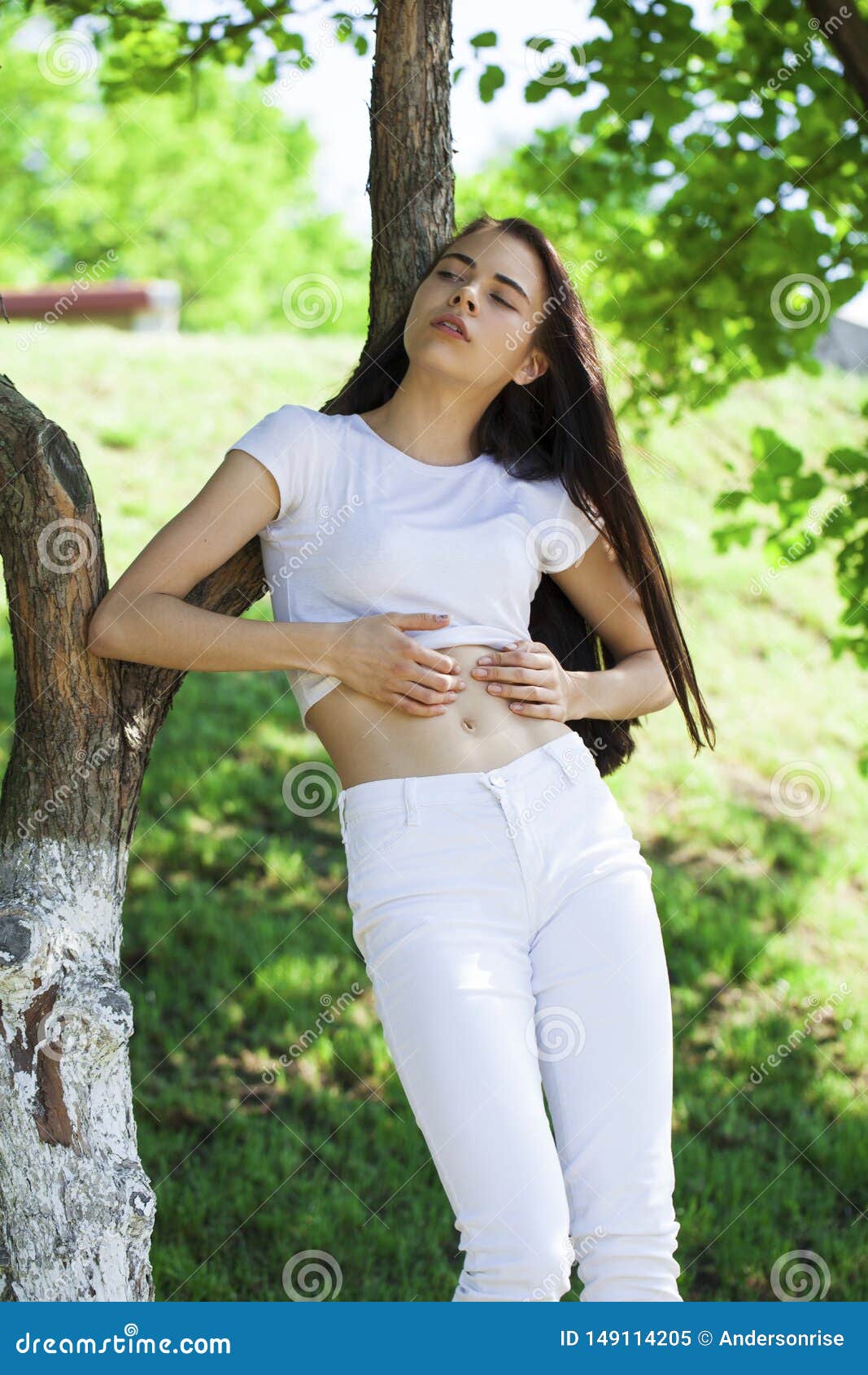 Beautiful Brunette Woman Posing Against Summer Park Bright Sunny 