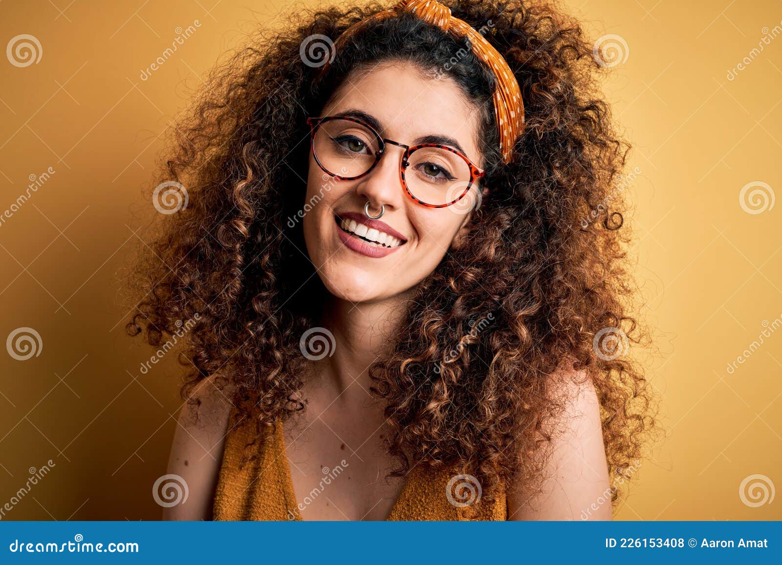 Beautiful Brunette Woman On Vacation With Curly Hair And Piercing Wearing Glasses And Diadem