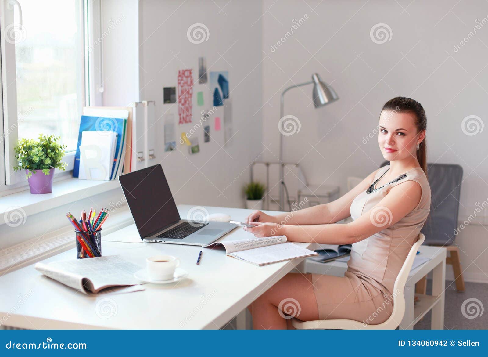 Beautiful Business Woman Working At Her Desk With Headset And Laptop