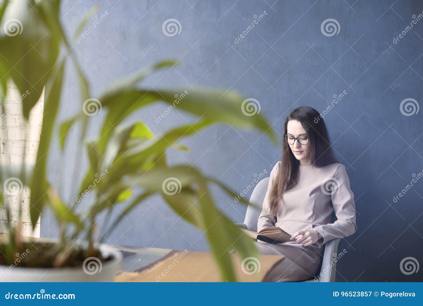 beautiful businesswoman wearing glasses sitting in loft office r