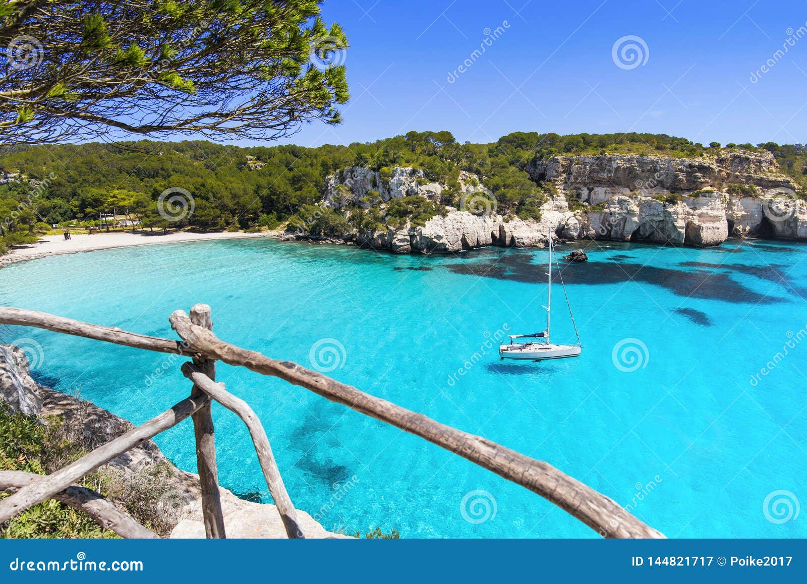 beautiful cala macarella beach, menorca island, spain. sailing boat in a bay. summer fun, enjoying life, yachting, travel and acti