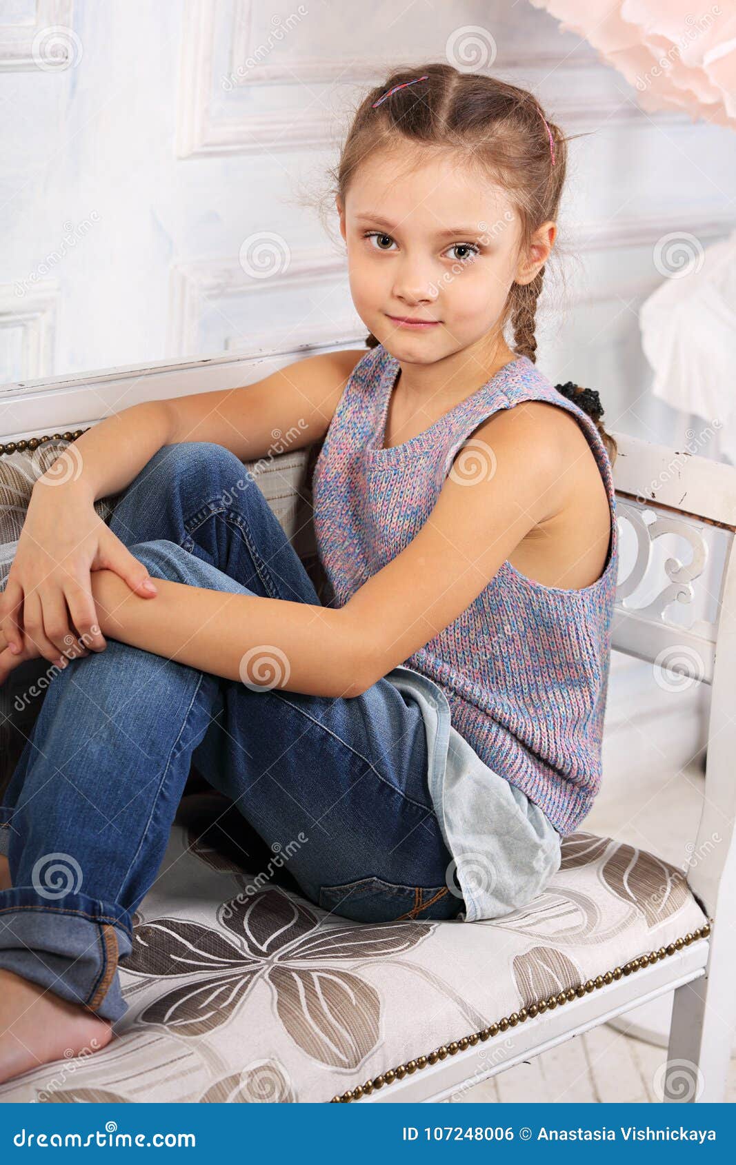 Beautiful Calm Smiling Kid Girl Sitting on the Bench in Blue Jeans and ...