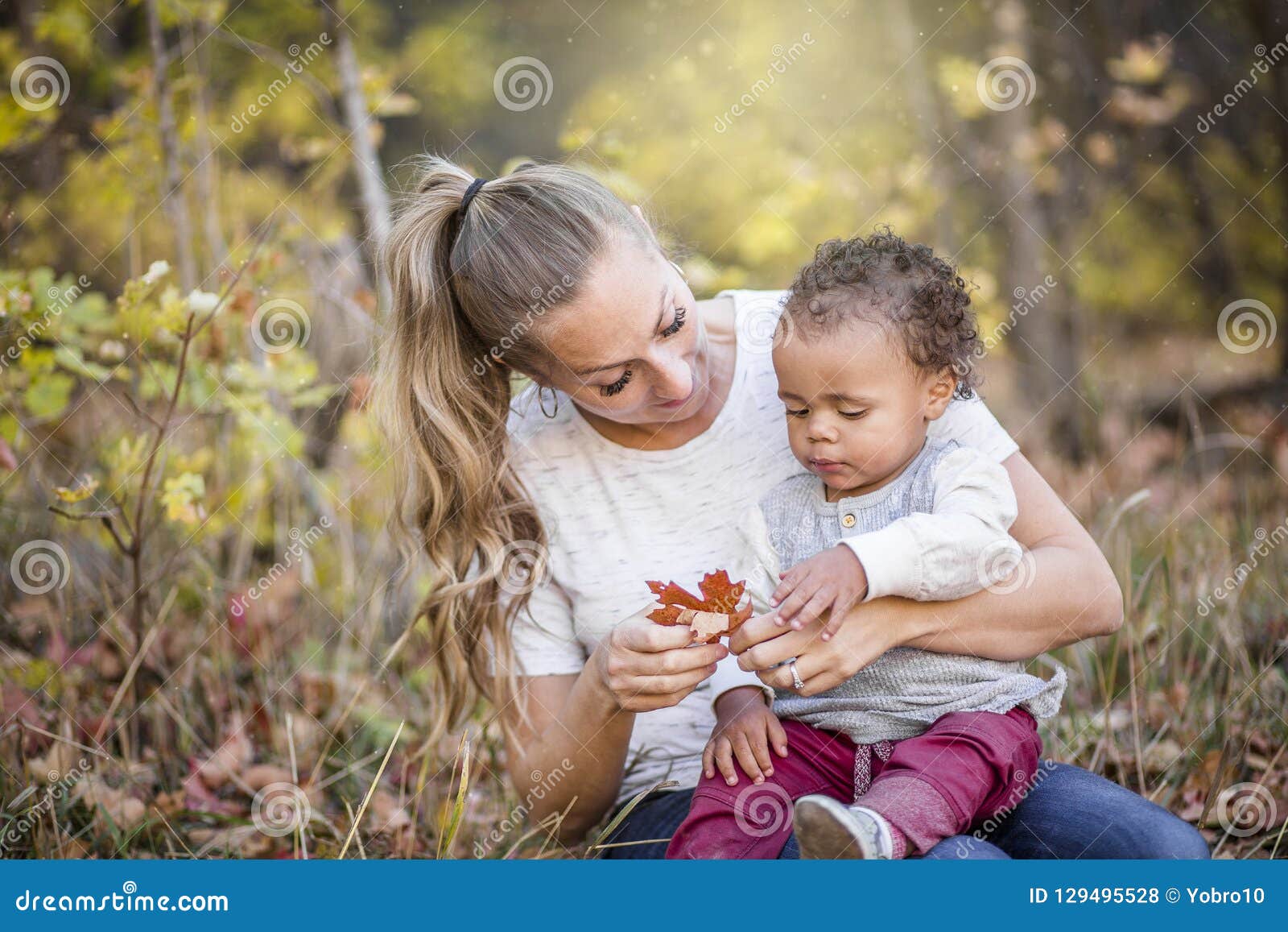 beautiful candid portrait of a mother playing with her cute bi-racial son
