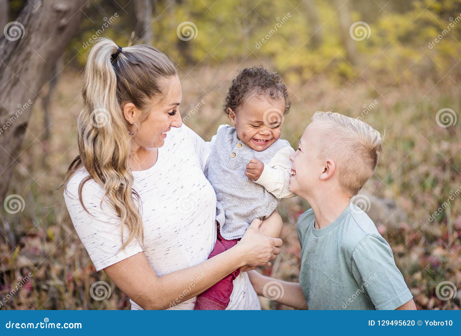 beautiful candid portrait of a mother playing with her cute bi-racial sons