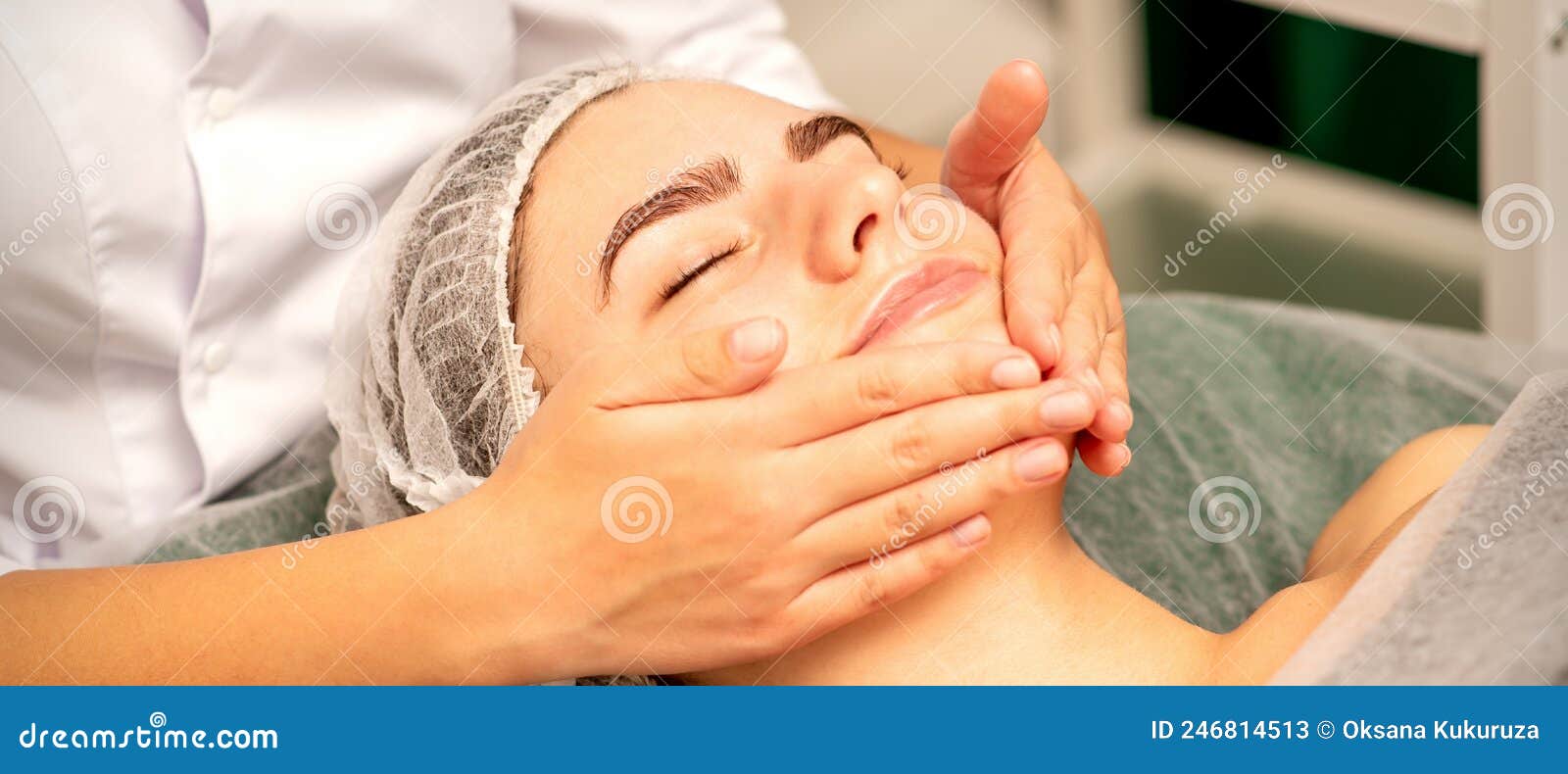 Beautiful Caucasian Young Woman Receiving A Facial Massage With Closed Eyes In Spa Salon Close