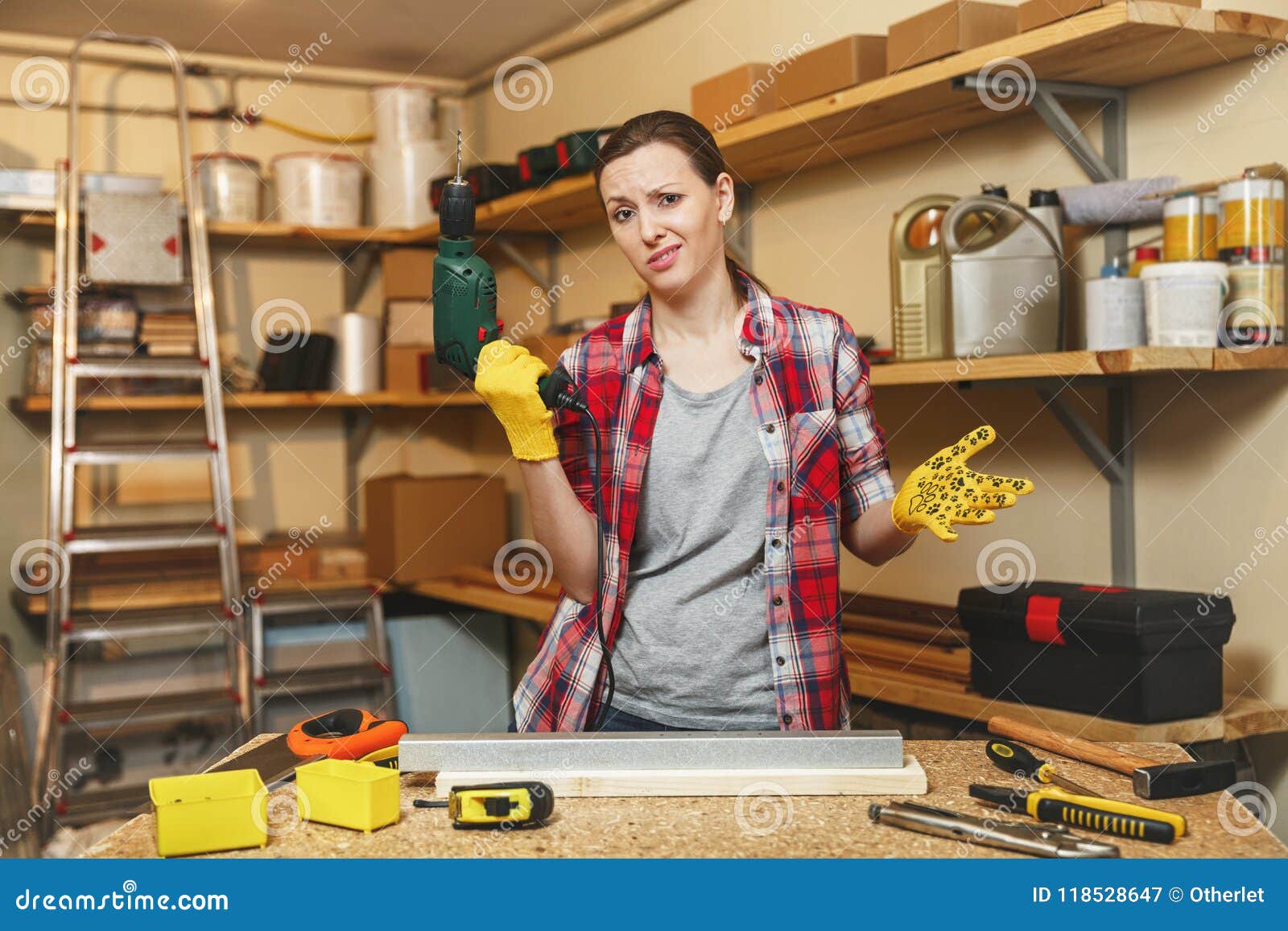 beautiful caucasian young woman working in carpentry workshop at table place