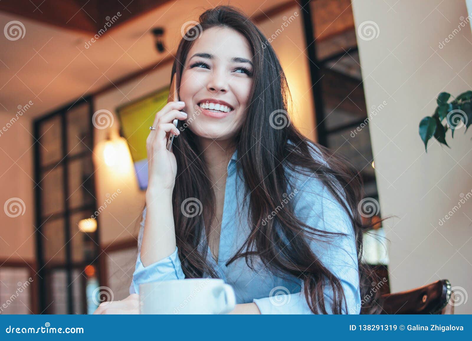 https://thumbs.dreamstime.com/z/beautiful-charming-brunette-happy-smiling-asian-girl-talking-smartphone-cafe-beautiful-charming-brunette-happy-smiling-138291319.jpg