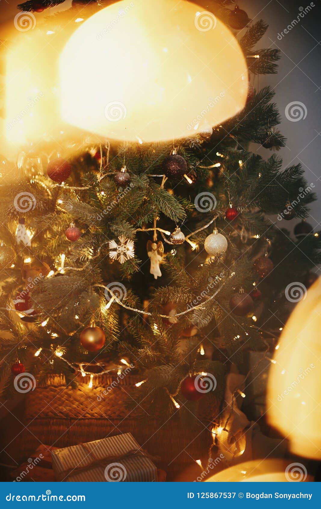 Beautiful Christmas Tree with Ornaments, Golden Lights and Presents in ...