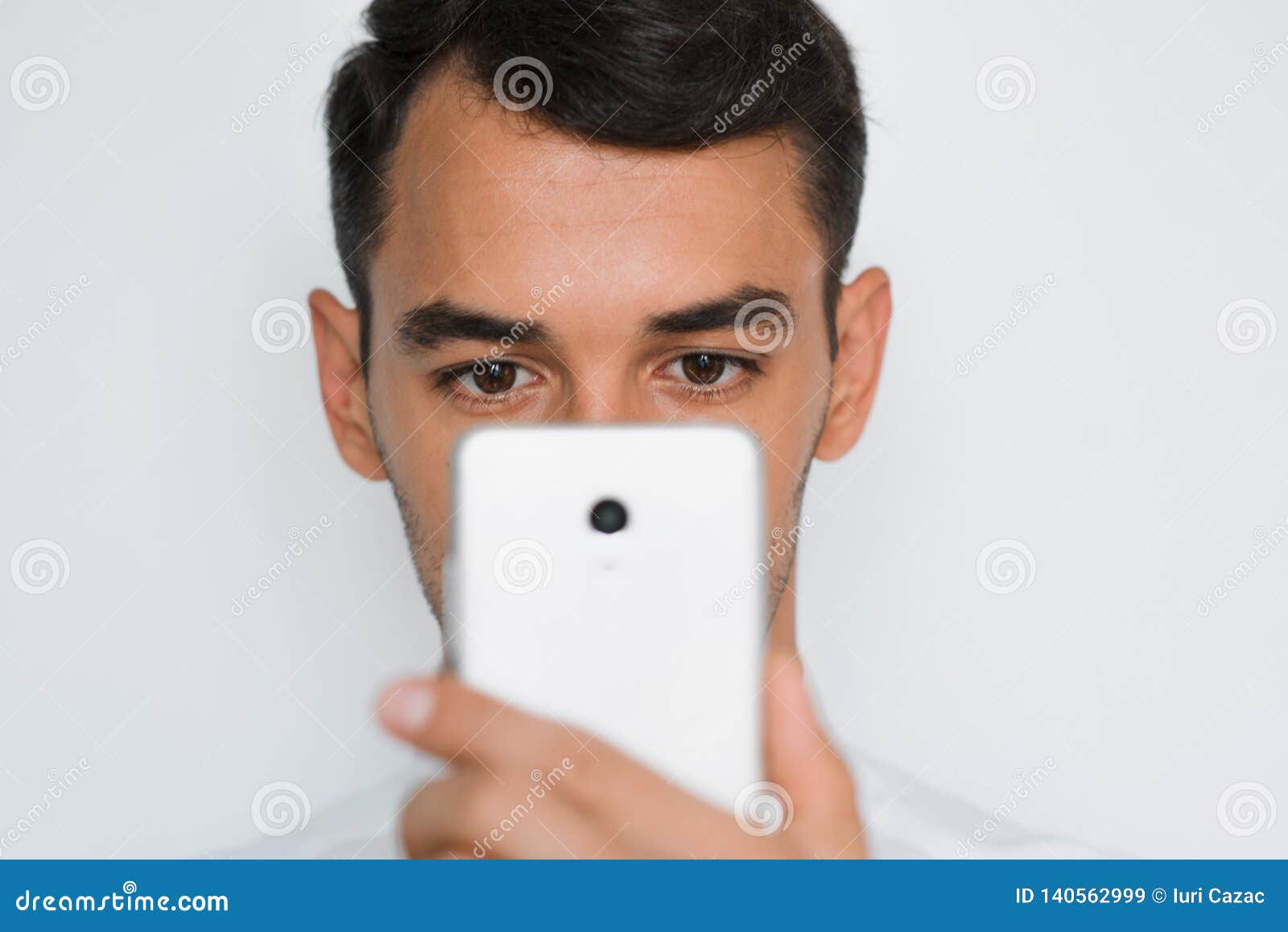 Beautiful Close-up Portrait of Young Man Using Mobile Phone on Gray ...