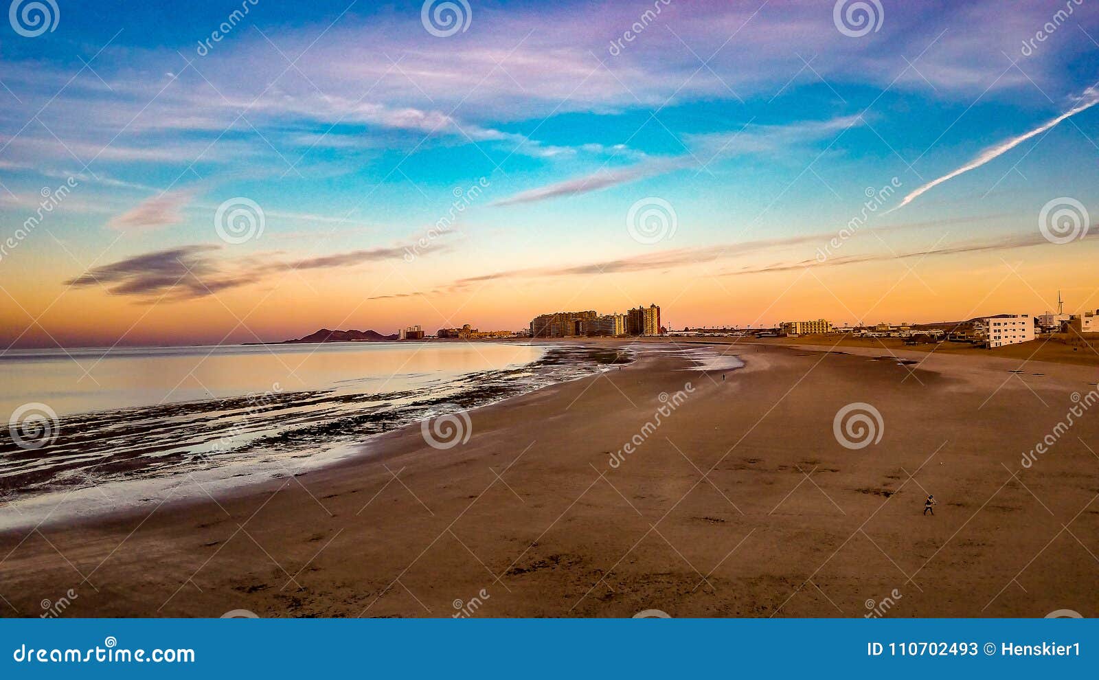 sunrise on the horizon at sandy beach, puerto penasco, mexico