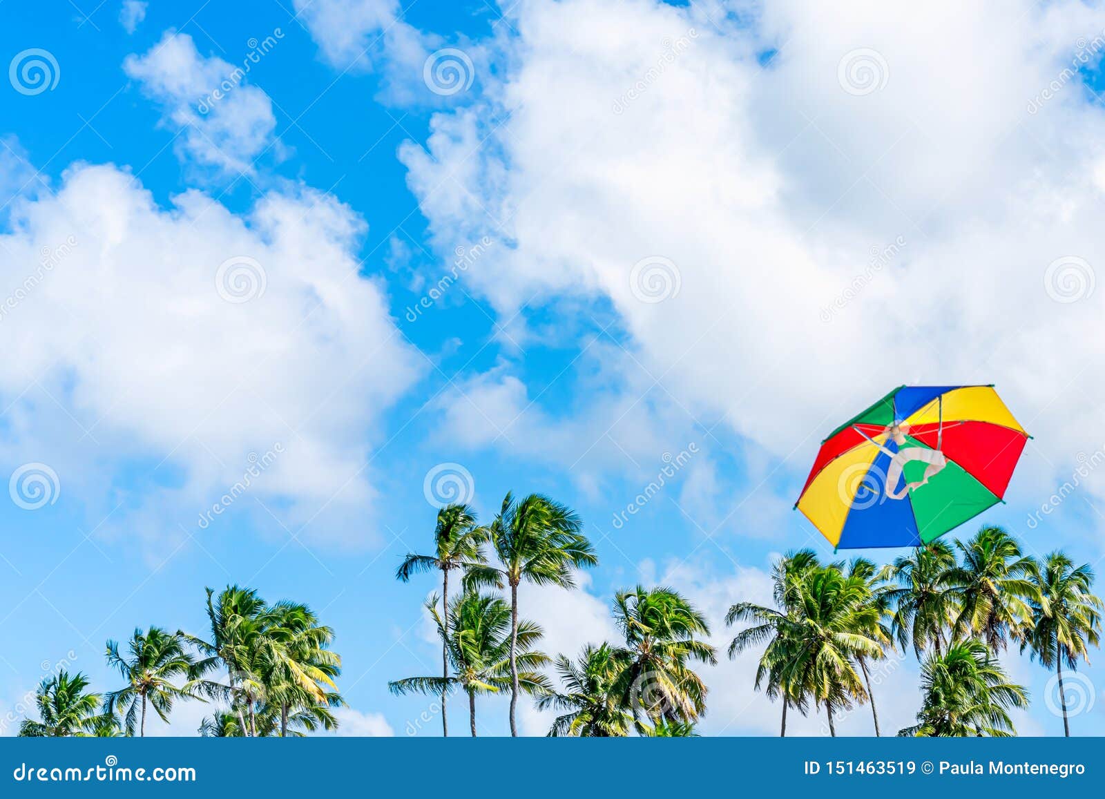 beautiful and colorful frevo umbrella kite flying in a blue sky day. it is a  of brazilian carnival decoration in the city
