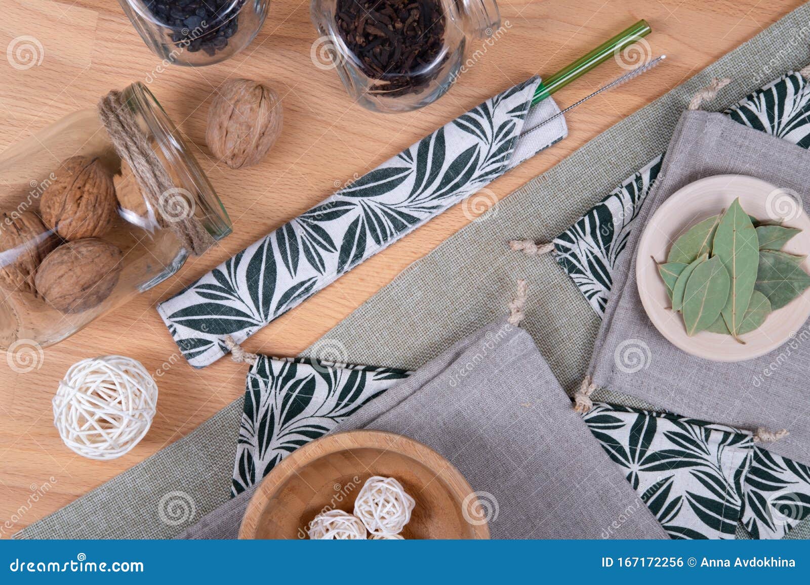 glass tube and linen baggies with walnuts and bay leaves.