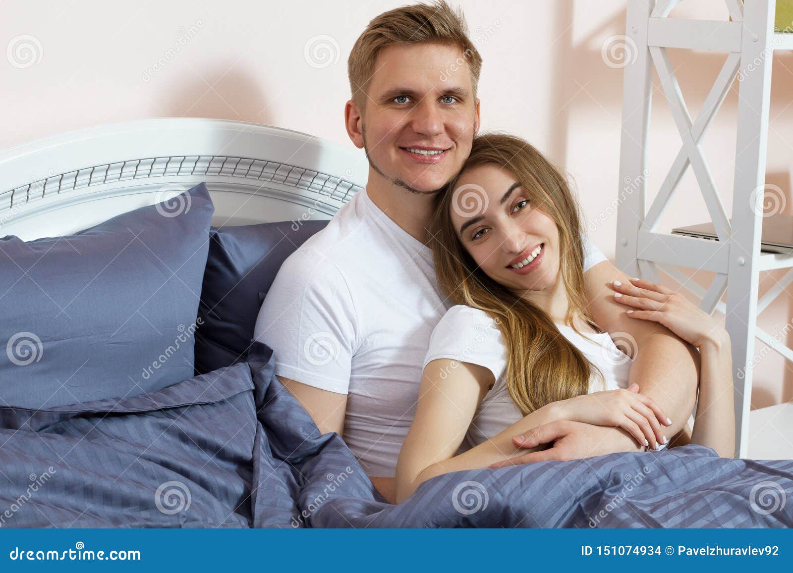 Beautiful Couple Hugging On Bed In Bedroom In The Morning
