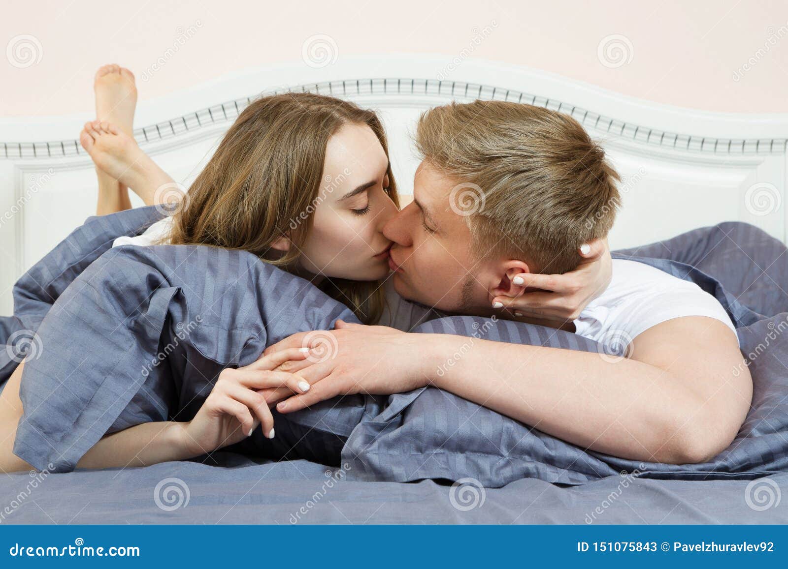 Beautiful Couple Kissing On Bed In Bedroom In The Morning