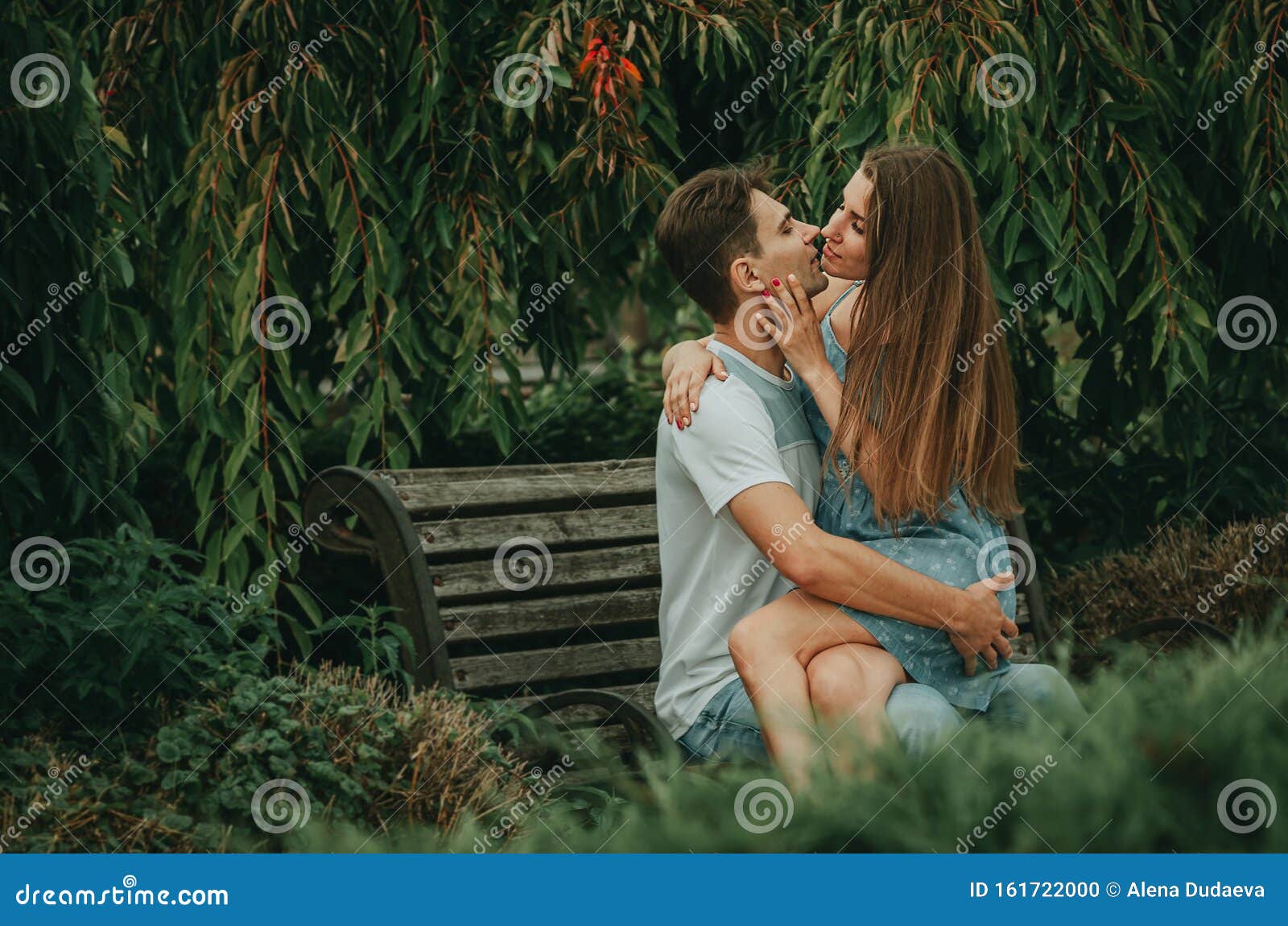 Beautiful Couple in Love Sits in a Park on a Bench in the Summer ...