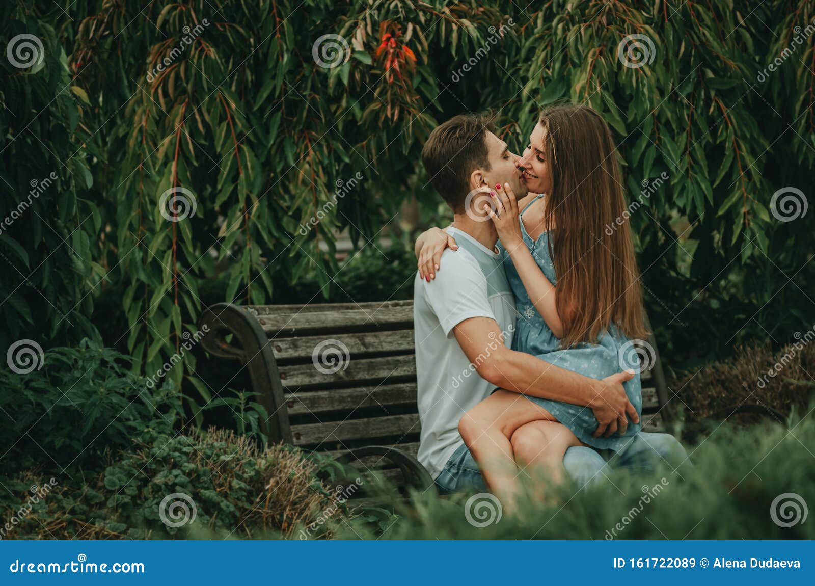 Beautiful Couple in Love Sits in a Park on a Bench in the Summer ...