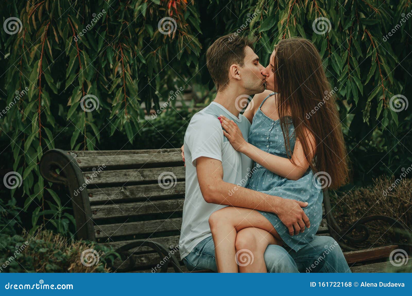 Beautiful Couple in Love Sits in a Park on a Bench in the Summer ...