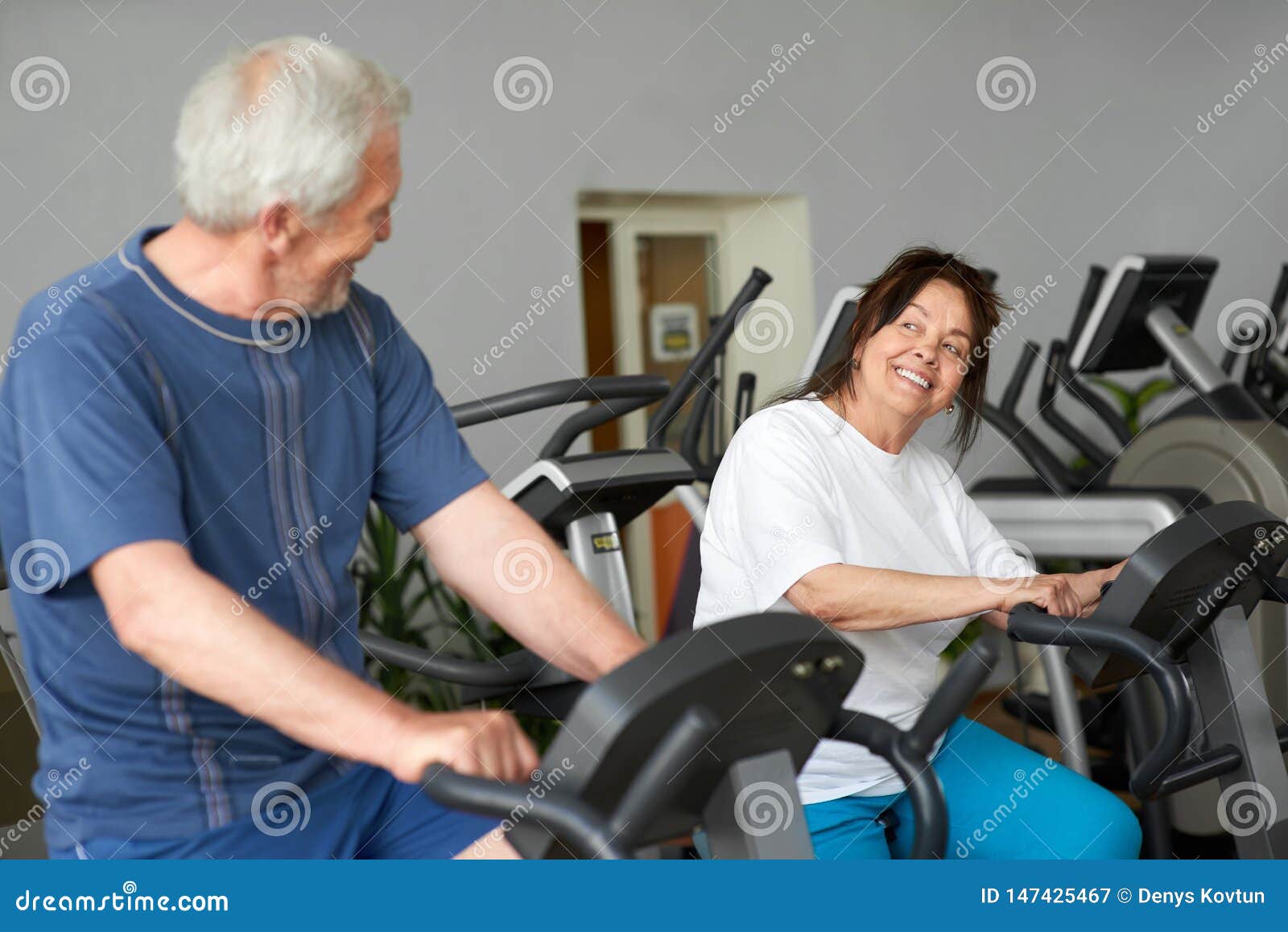 Beautiful Couple of Seniors Working Out at Gym. Stock Image