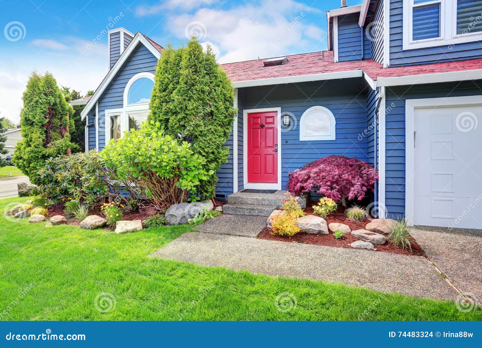 beautiful curb appeal with blue exterior paint and red roof.