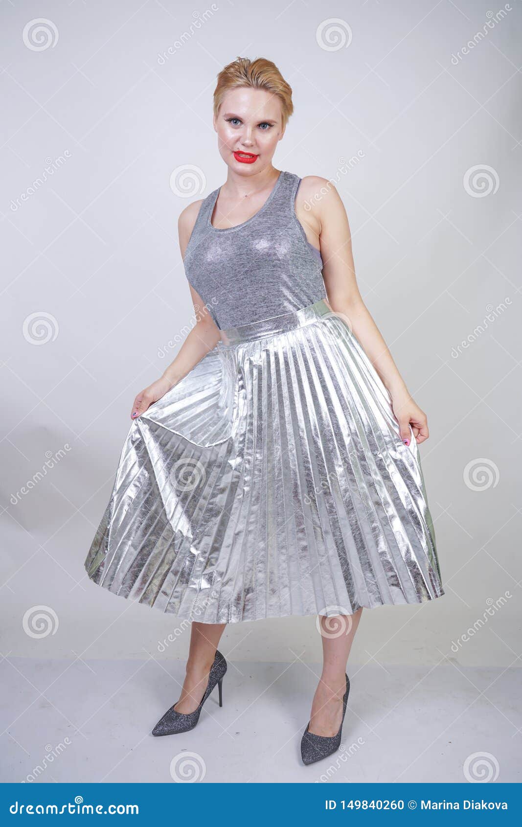 Beautiful Curvy Girl with Short Hair in Silver Tank Top and Metallic ...