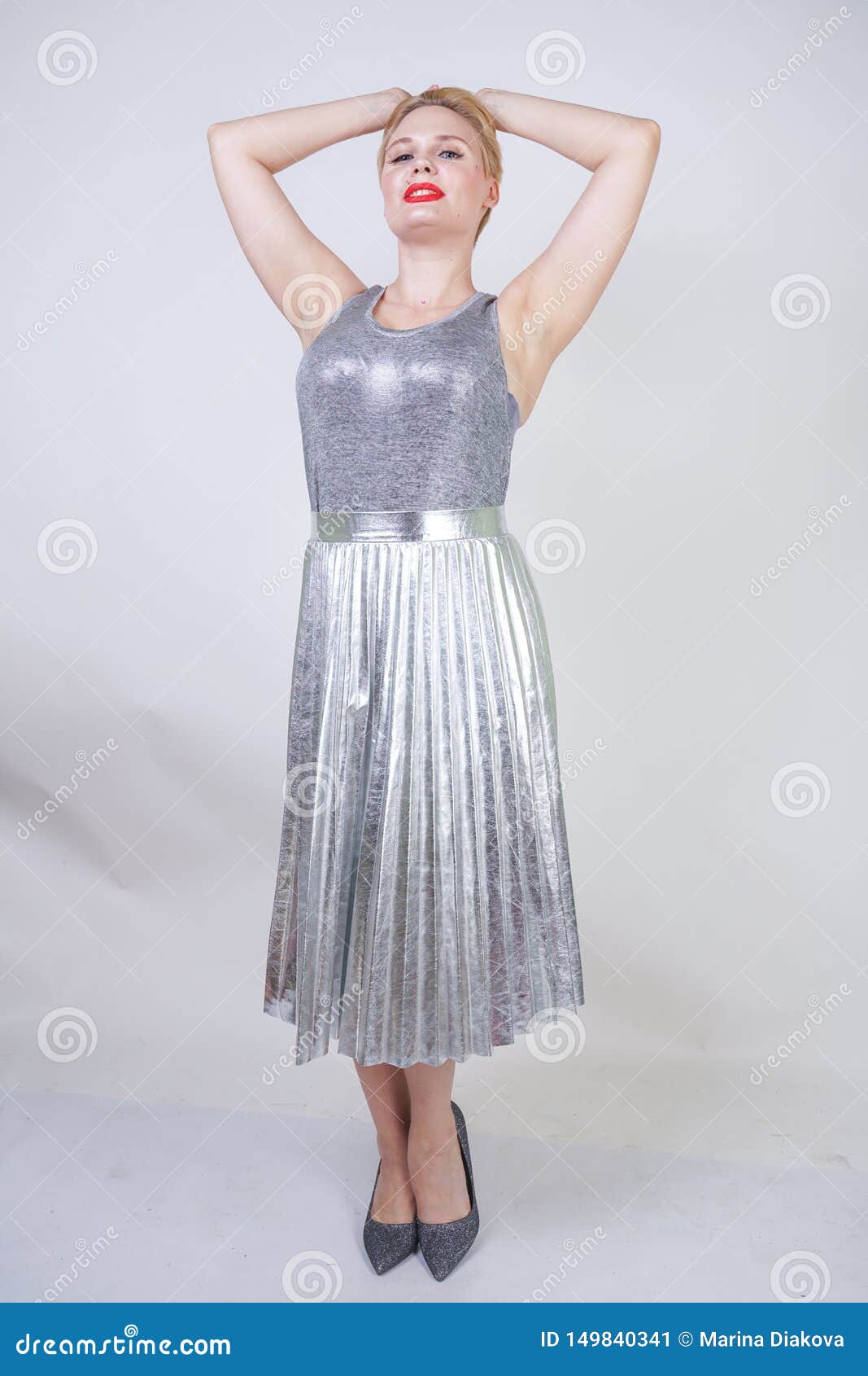 Beautiful Curvy Girl with Short Hair in Silver Tank Top and Metallic Pleated Skirt Stands White Background in Studio. Blonde Pl Stock Image - of artistic, attractive: 149840341
