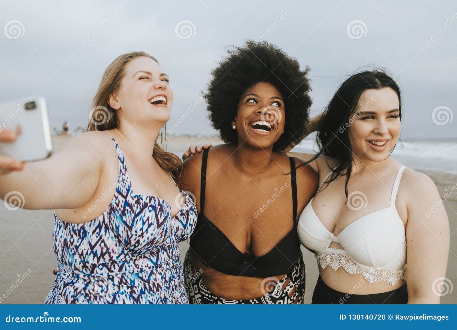 Beautiful Curvy Women Taking a Selfie at the Beach Stock Photo