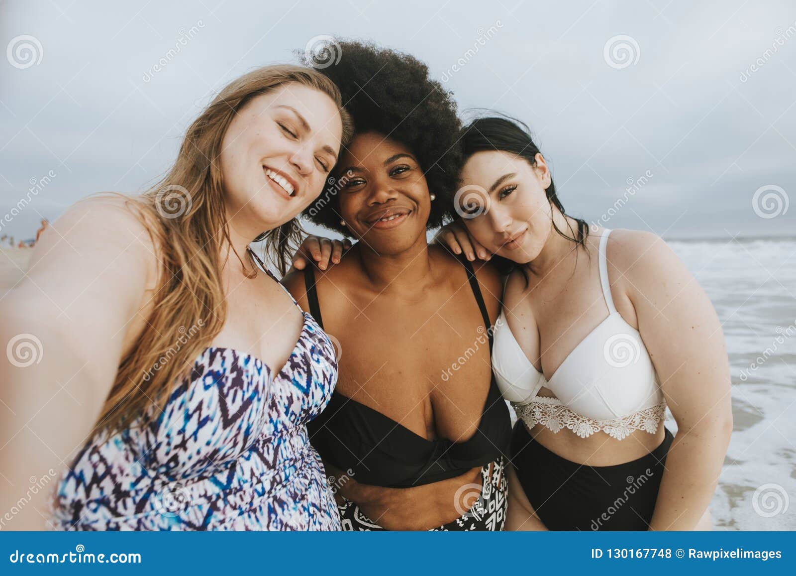 beautiful curvy women taking a selfie at the beach