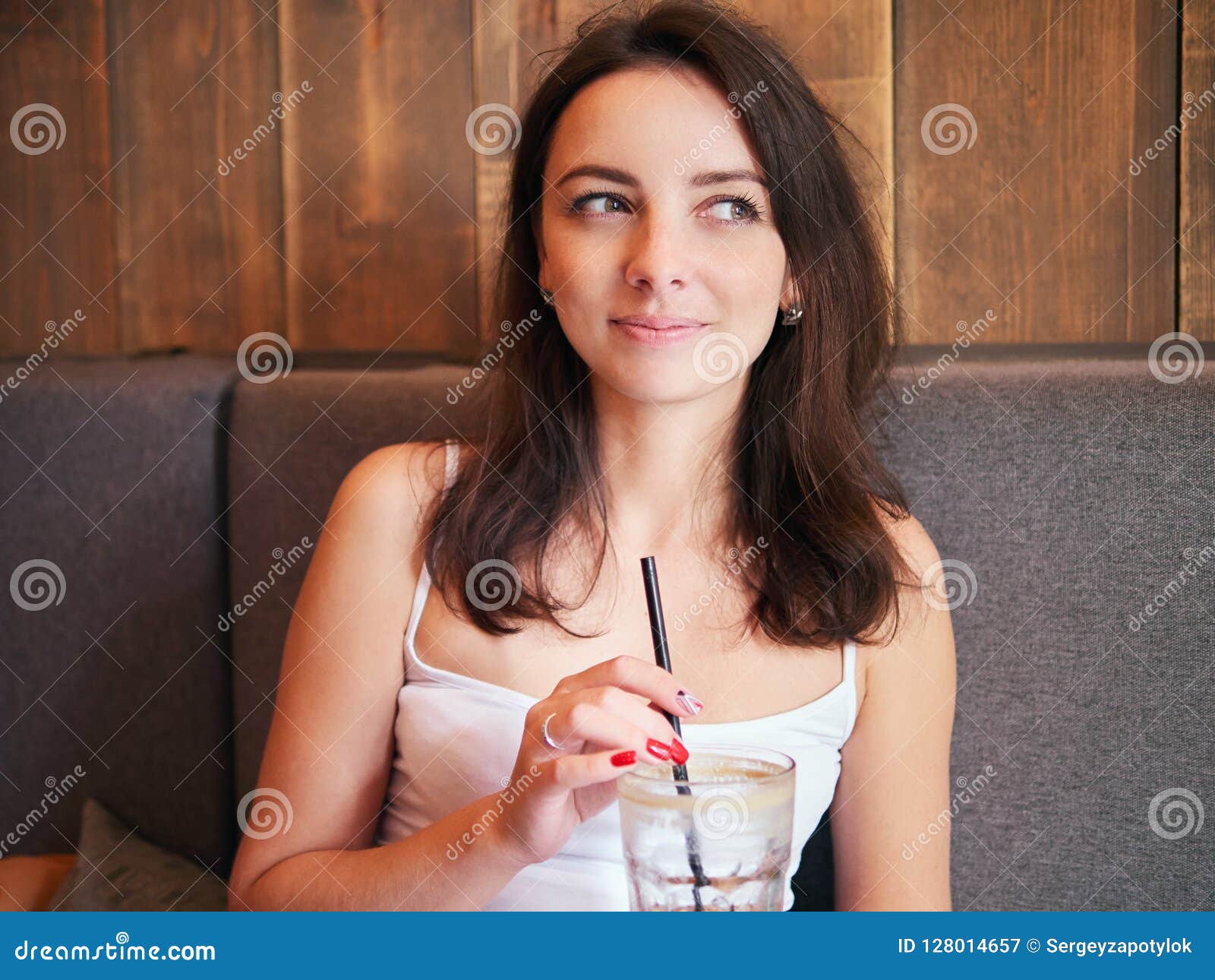 Beautiful Cute Brunette Girl Sitting In The Cozy Cafe Near The Window 