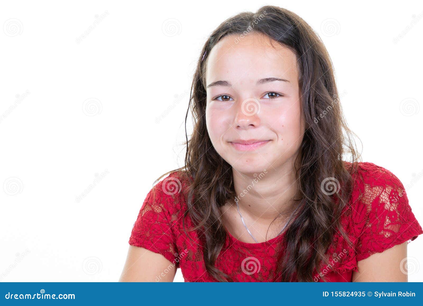 Portrait of caucasian teen girl, isolated on white background. Beautiful  young teenager smiling with wind in her hair. Happy cute child laughing.  Stock Photo
