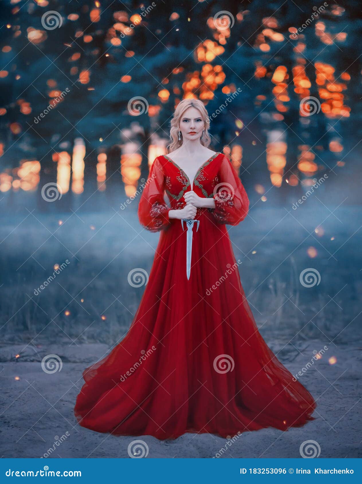 Beautiful, Dangerous Blonde Queen in a Red Fashion Lush Dress with
