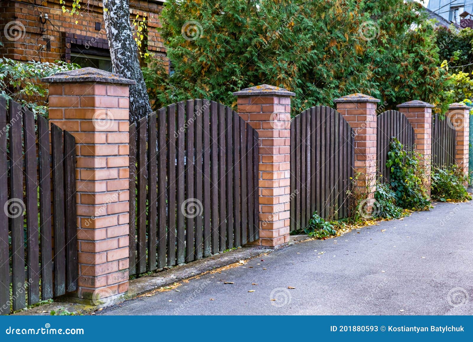 Beautiful Decorative Modern Wooden Fence with Brick Columns Stock Image