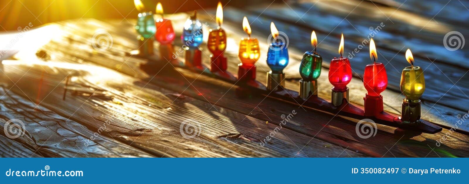 a beautiful display of colorful, glowing candles on a rustic wooden table